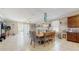 Bright living room connecting to the dining and kitchen areas, with sliding doors to a refreshing pool at 5457 Animosh Ct, Polk City, FL 33868