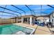 Outdoor view of the pool and screened porch with ample seating and dining area at 5457 Animosh Ct, Polk City, FL 33868