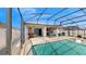Outdoor pool and screened porch with BBQ grill and dining set at 5457 Animosh Ct, Polk City, FL 33868