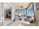 Relaxing screened porch featuring a fireplace, comfortable seating, and outdoor umbrella at 5457 Animosh Ct, Polk City, FL 33868