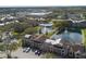 Beautiful aerial view of a community featuring a swimming pool, pond with fountains, lush landscaping, and well-maintained buildings at 5530 Chrishire Way # D204, Orlando, FL 32822