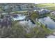 Aerial view showcases a community pool, pond, and well-maintained apartment buildings at 5530 Chrishire Way # D204, Orlando, FL 32822