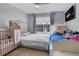 Cozy bedroom with tile floors, multiple beds, TV, and a view of the water fountain outside at 5530 Chrishire Way # D204, Orlando, FL 32822