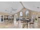 Bright clubhouse with elegant seating, ceiling fan, and a serene view of the pond at 5530 Chrishire Way # D204, Orlando, FL 32822