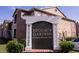 Exterior shot of the 'Regency Gardens Condominiums' community sign with lush green bushes and a glimpse of brick building at 5530 Chrishire Way # D204, Orlando, FL 32822