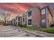Tan and brick two-story condo complex with parking and well-maintained landscaping at 5530 Chrishire Way # D204, Orlando, FL 32822