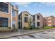 Two-story condo with tan siding, well-maintained landscaping and visible parking area at 5530 Chrishire Way # D204, Orlando, FL 32822