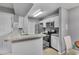 Bright kitchen with white cabinets, granite countertops, stainless steel appliances at 5530 Chrishire Way # D204, Orlando, FL 32822