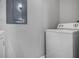Convenient laundry area featuring a white washing machine and gray walls at 5530 Chrishire Way # D204, Orlando, FL 32822