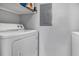 A functional laundry area showcasing a white dryer and gray walls at 5530 Chrishire Way # D204, Orlando, FL 32822
