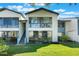 Attractive condo building with large windows, private stairs, and green lawn presents a welcoming exterior in a community at 6 Escondido Cir # 58, Altamonte Springs, FL 32701
