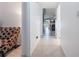 Hallway with tile floors leading to a living area with a comfortable chair at 6 Escondido Cir # 58, Altamonte Springs, FL 32701