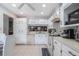Spacious kitchen with white cabinets, tile floors and view into dining space at 6 Escondido Cir # 58, Altamonte Springs, FL 32701
