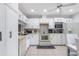 Bright white kitchen with tile flooring, appliances, and ample cabinet space at 6 Escondido Cir # 58, Altamonte Springs, FL 32701