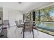 Enclosed lanai with dining table and chairs overlooking a tranquil lake view at 6 Escondido Cir # 58, Altamonte Springs, FL 32701
