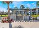 Community outdoor patio area with pergola, tables, and seating overlooking the pond at 6 Escondido Cir # 58, Altamonte Springs, FL 32701