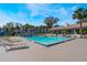 Community pool with lounge chairs and tables for relaxing poolside at 6 Escondido Cir # 58, Altamonte Springs, FL 32701