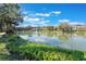 Beautiful view of a lake with fountain, reflecting community residences under a bright sky, highlighting natural beauty at 6 Escondido Cir # 58, Altamonte Springs, FL 32701