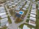 Aerial view of community showing layout of homes, pool, and shuffleboard courts at 6475 Peppertree Ne Path, Winter Haven, FL 33881
