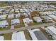 An elevated perspective of the community, highlighting the homes and nearby landscapes at 6475 Peppertree Ne Path, Winter Haven, FL 33881