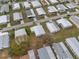 A bird's eye view of the community displaying the layout of homes and surrounding greenery at 6475 Peppertree Ne Path, Winter Haven, FL 33881