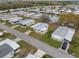 Aerial of the homes showcasing neat landscaping, driveways, and well-maintained lawns at 6475 Peppertree Ne Path, Winter Haven, FL 33881