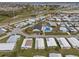 An aerial view of the community showcasing the mobile homes, landscaping, pool, and surrounding areas at 6475 Peppertree Ne Path, Winter Haven, FL 33881
