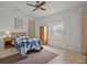 Well-lit bedroom with a comfy bed, a ceiling fan, and ample storage space creating a serene atmosphere at 6475 Peppertree Ne Path, Winter Haven, FL 33881