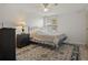 Cozy bedroom with a dark metal bed frame, a patterned rug, and soft lighting, offering a calming retreat at 6475 Peppertree Ne Path, Winter Haven, FL 33881
