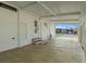 A spacious carport featuring a textured floor and an entrance to the home, offering convenient parking at 6475 Peppertree Ne Path, Winter Haven, FL 33881