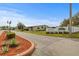 Brookhaven Village community entrance with lush landscaping and well-maintained sign at 6475 Peppertree Ne Path, Winter Haven, FL 33881