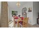 Cozy dining area featuring a wooden table, bright light fixture, and views into the kitchen at 6475 Peppertree Ne Path, Winter Haven, FL 33881