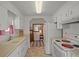 Functional kitchen with white appliances, ample cabinet space, and an adjacent dining area, perfect for cooking at 6475 Peppertree Ne Path, Winter Haven, FL 33881