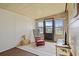 Inviting sunroom with a rocking chair and a comfortable setting with natural light and access to the outdoors at 6475 Peppertree Ne Path, Winter Haven, FL 33881