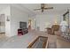 Inviting living room features plush carpeting, a ceiling fan, and comfortable seating, great for relaxing at 6475 Peppertree Ne Path, Winter Haven, FL 33881