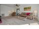 Comfortable living room with sliding doors to the lanai, neutral tones, and ample natural light at 6475 Peppertree Ne Path, Winter Haven, FL 33881