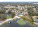 An aerial view shows the community in-ground pool, gazebo, and lake access at 734 Olympic Cir # 30, Ocoee, FL 34761