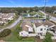 This aerial view highlights the community tennis courts near surrounding homes at 734 Olympic Cir # 30, Ocoee, FL 34761