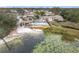 An aerial view shows a gazebo, sandy area, and in-ground pool near the water at 734 Olympic Cir # 30, Ocoee, FL 34761