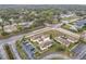 Aerial view of the property with a parking area, nearby roadways, and surrounding homes at 734 Olympic Cir # 30, Ocoee, FL 34761