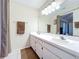 Bright bathroom featuring double sinks, ample counter space and a large mirror at 734 Olympic Cir # 30, Ocoee, FL 34761