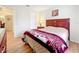 Well-lit bedroom featuring wood laminate flooring and ample closet space at 734 Olympic Cir # 30, Ocoee, FL 34761