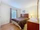Inviting bedroom with natural light, wood floors, and a classic dresser set at 734 Olympic Cir # 30, Ocoee, FL 34761