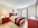 Cozy bedroom with natural light, wood furniture, and a comfortable bed at 734 Olympic Cir # 30, Ocoee, FL 34761