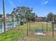 A fenced dog park with a bench and partial shade provides an attractive outdoor amenity at 734 Olympic Cir # 30, Ocoee, FL 34761