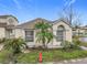 Well-kept home featuring desert landscaping, concrete walkway, and covered porch at 734 Olympic Cir # 30, Ocoee, FL 34761