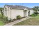 Well-kept home featuring desert landscaping, concrete walkway, and covered porch at 734 Olympic Cir # 30, Ocoee, FL 34761