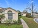 Well-kept home featuring desert landscaping, concrete walkway, and covered porch at 734 Olympic Cir # 30, Ocoee, FL 34761