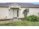 Inviting front entrance with concrete steps, neutral paint, and desert landscaping at 734 Olympic Cir # 30, Ocoee, FL 34761