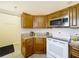 Cozy kitchen with granite countertops, stainless steel microwave, and white oven at 734 Olympic Cir # 30, Ocoee, FL 34761